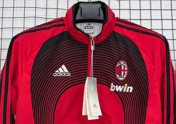 Red Adidas AC Milan windbreaker 2025 with a stylish design and logo for fans