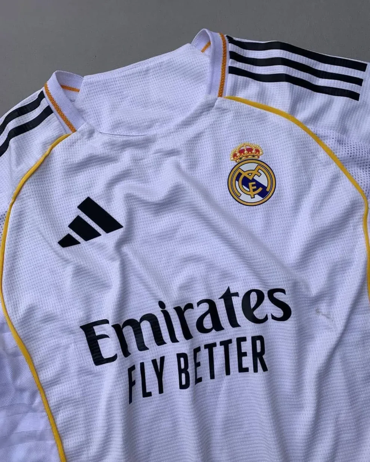 Real Madrid 2025 home jersey The Dribble Store white club kit with gold trim Adidas logo and Emirates sponsor