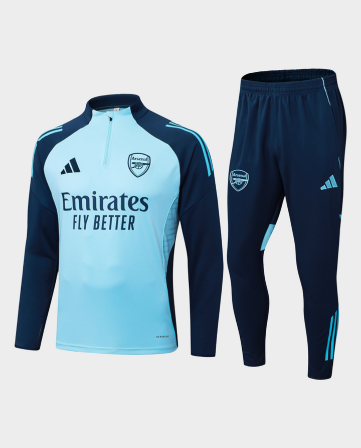 The Dribble Store Arsenal blue training suit 2025-26 featuring a zip-up top and fitted pants