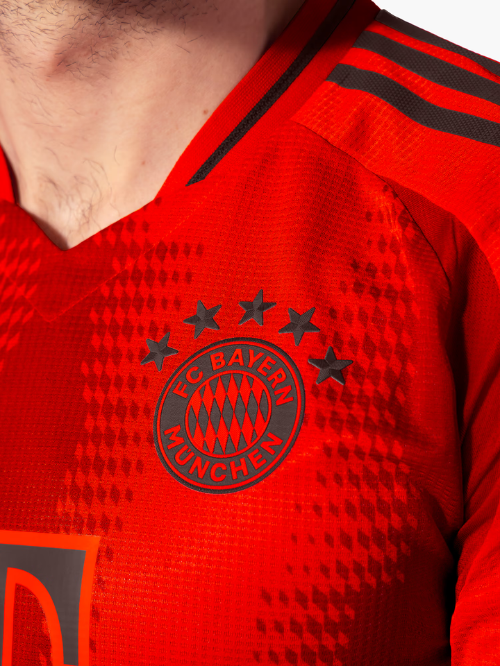 Close-up of Bayern Munich 2024-25 jersey featuring team logo and star detailing.