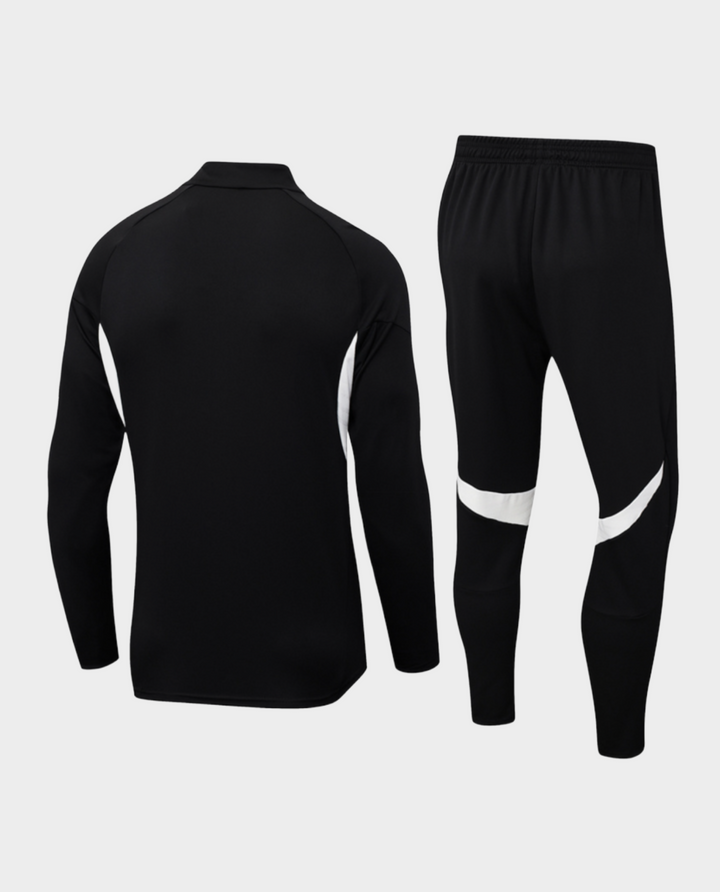 The Dribble Store Liverpool training suit 2025-26 in black with white accents, featuring a zip-up top and fitted pants