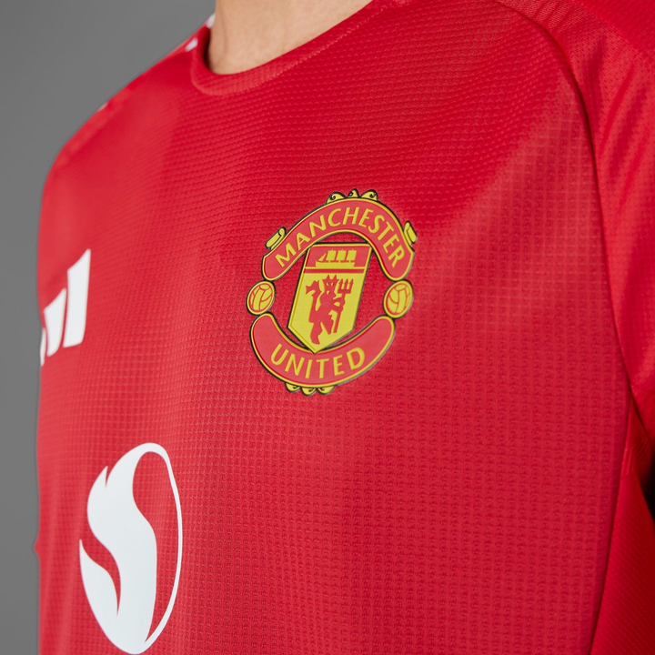 Manchester United 2024 home jersey featuring the iconic club crest in vibrant red color