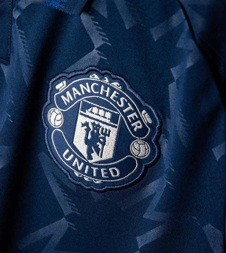 Manchester United away jersey 2024 featuring the club crest in detailed embroidery