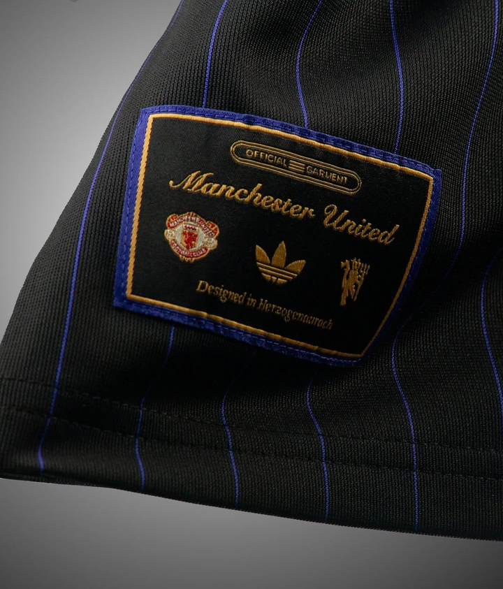 Close-up of the Manchester United Terrace Icon jersey 2025-26 label showing logo details