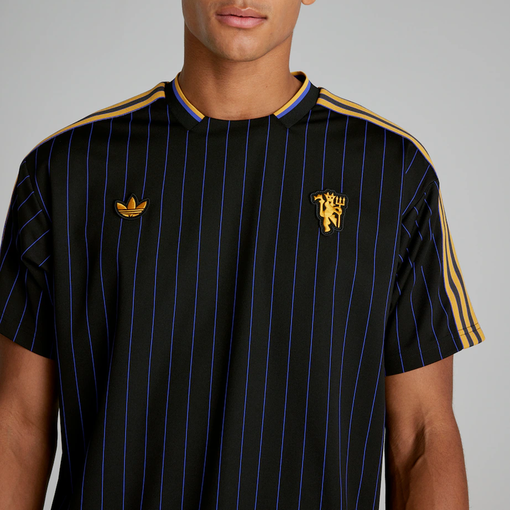 The Dribble Store Manchester United Terrace Icon jersey 2025-26 with black and blue striped design