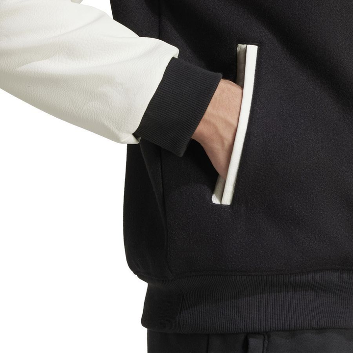 The Dribble Store Manchester United varsity jacket 2025-26 with stylish color-blocked design and side pockets