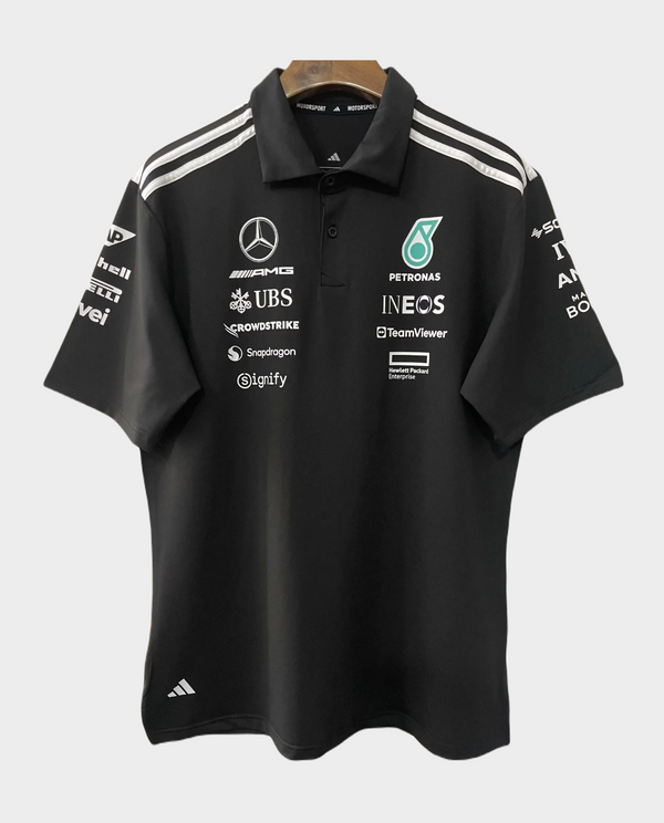 Mercedes AMG Petronas F1 polo 2025 in black with sponsor logos and Adidas branding