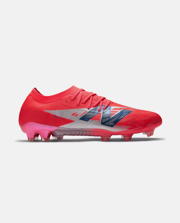 New Balance Furon Elite V8 soccer cleats in red with blue logo and football stud design