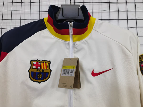 Barcelona windbreaker jacket 2025-26 in white with vibrant team details and Nike logo