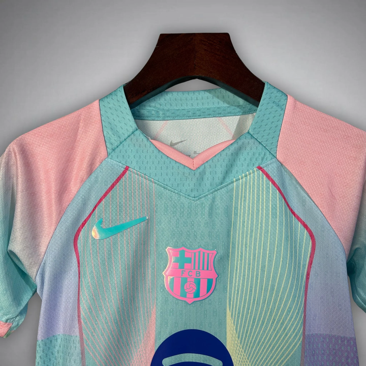 The Dribble Store FC Barcelona Blue Edition Jersey 2025-26 pastel aqua and pink Nike crest front view on hanger