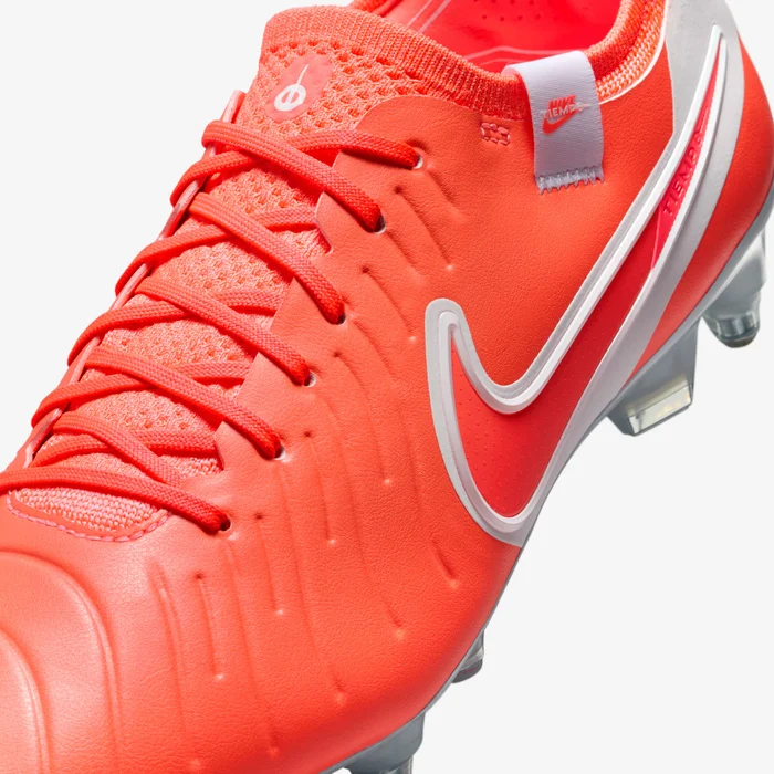 Close-up of bright red Nike Tiempo Legend 10 Elite FG soccer cleats with white Nike swoosh