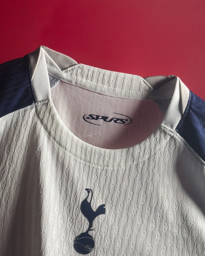 The Dribble Store close up of Tottenham Hotspur 2025 home jersey white textured fabric and crest