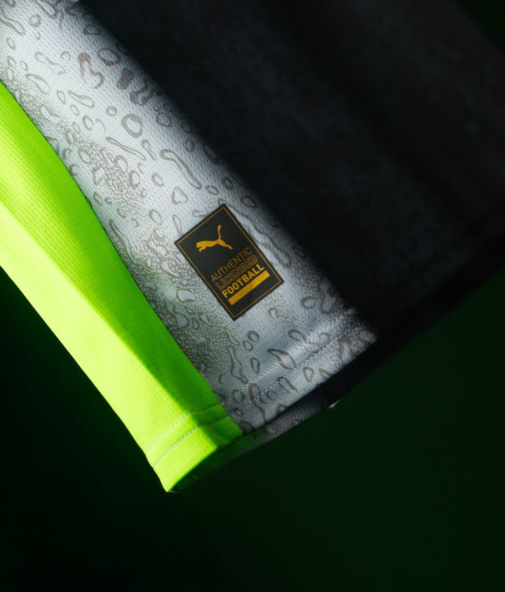The Dribble Store close up of Manchester City Third Jersey 2025-26 hem with Puma Authentic Football label and neon trim