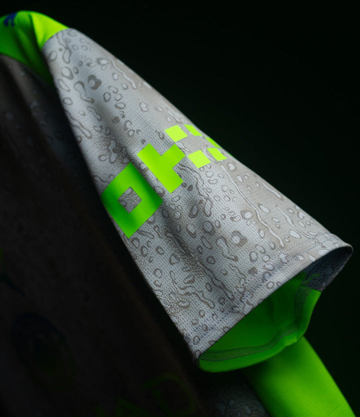 The Dribble Store close up of Manchester City Third Jersey 2025-26 gray sleeve with water droplet print and neon green trim