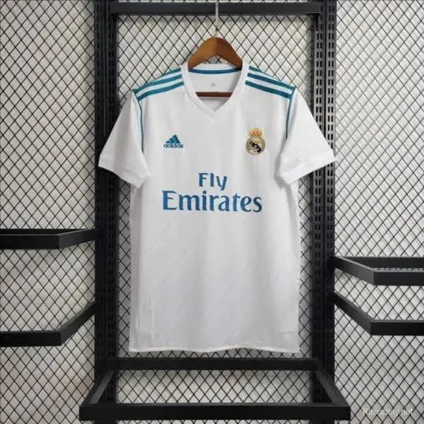 Real Madrid Home Jersey 2017-18 displayed on a hanger with a modern design